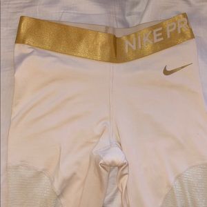 Champagne and gold Nike Pro FLEECE leggings.
